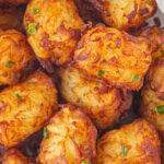 Closeup view of homemade tater tots showing the crispy crusts. Title text overlay for Pinterest.