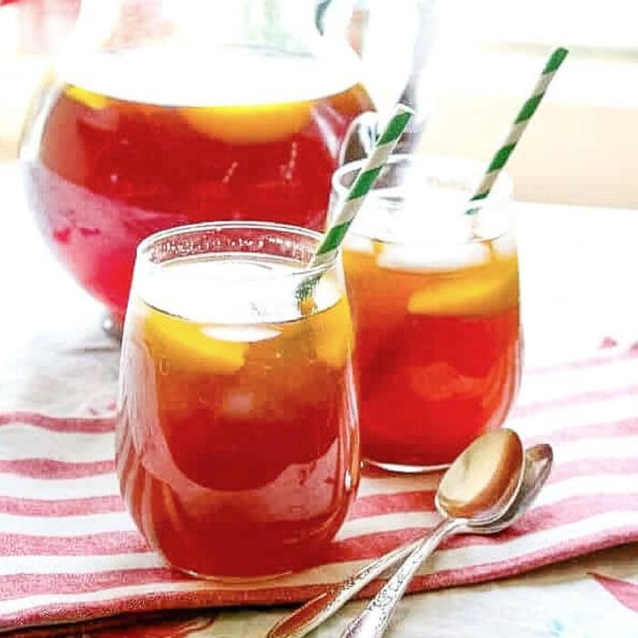 a closeup of a glass of peach tea.