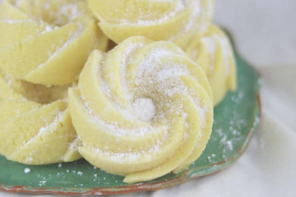 closeup of small lemon pound cakes dusted with sugar.