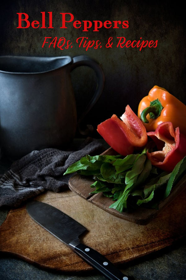 red and orange bell peppers on a cutting board.