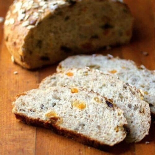 Slices of freshly baked muesli bread showing the dried fruit inside.