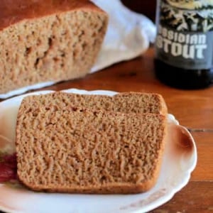 two slices of brown bread with a beer bottle nearby