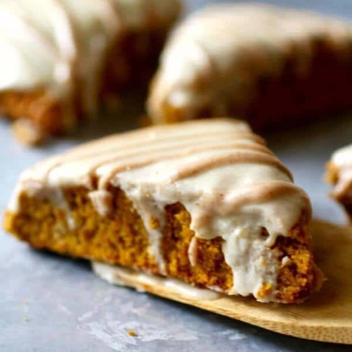 Baked pumpkin scones glazed with icing.
