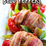 Red bell peppers stuffed with meatloaf and wrapped with bacon on a platter. Text overlay for Pinterest