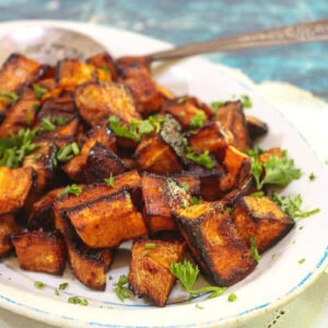 Finished roasted sweet potato cubes on a serving platter..