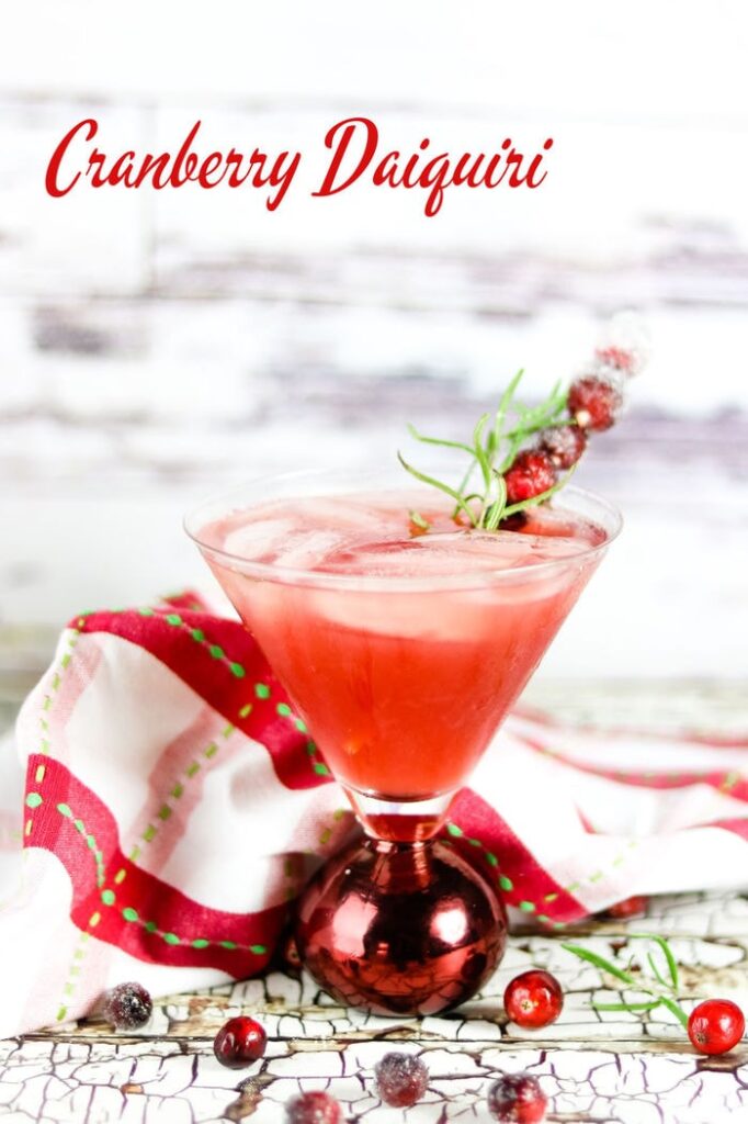 Cranberry daiquiri in a martini glass. Title text overlay.