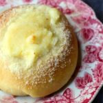 cream cheese kolache on a red and white plate