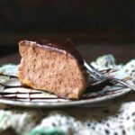 slice of chocolate Irish cream cheesecake with a shiny chocolate glaze