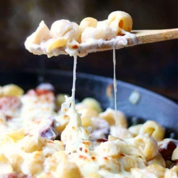 a serving of sausage alfredo bing removed from a skillet