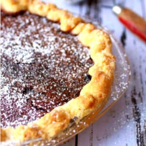 Close up of chocolate chess pie waiting to be sliced.