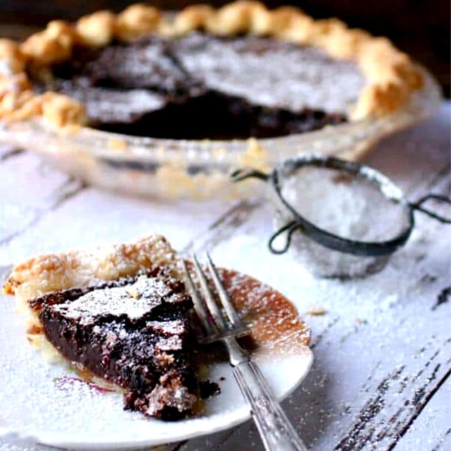 Slice of chocolate chess pie on a vintage plate.