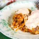 Stuffed Cabbage Roll cut in half to show the beef mixture inside.