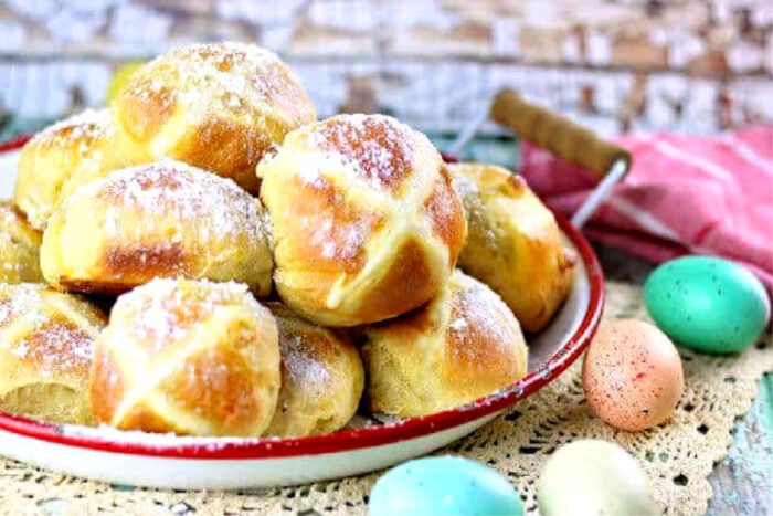 Finished hot cross buns on a tray showing the crosses on top.