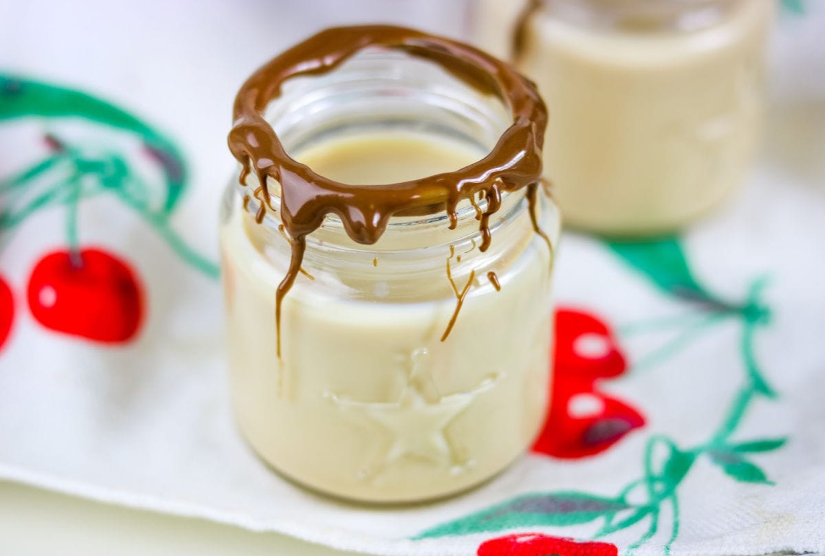 A creamy Jameson and Bailey's whiskey shooter garnished with melted chocolate.