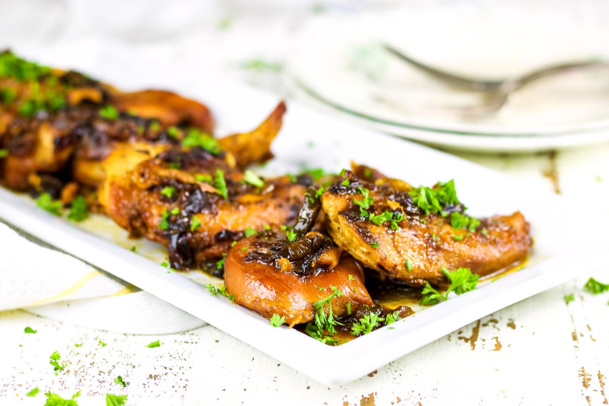 Chicken breasts on a whit platter ready to be served.