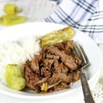 Macro of the finished Mississippi pot roast with rice on the side to show the juiciness and tender texture of the meat.