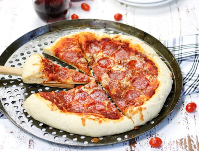 Baked pizza on a round pan.