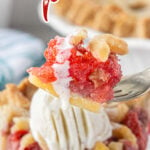 A slice of strawberry rhubarb pie with a title text overlay for Pinterest.