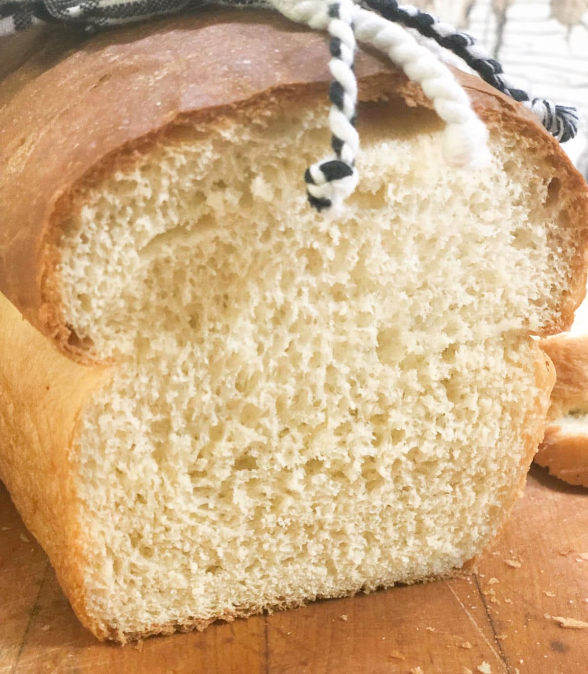 Loaf of buttermilk bread sliced to show interior.