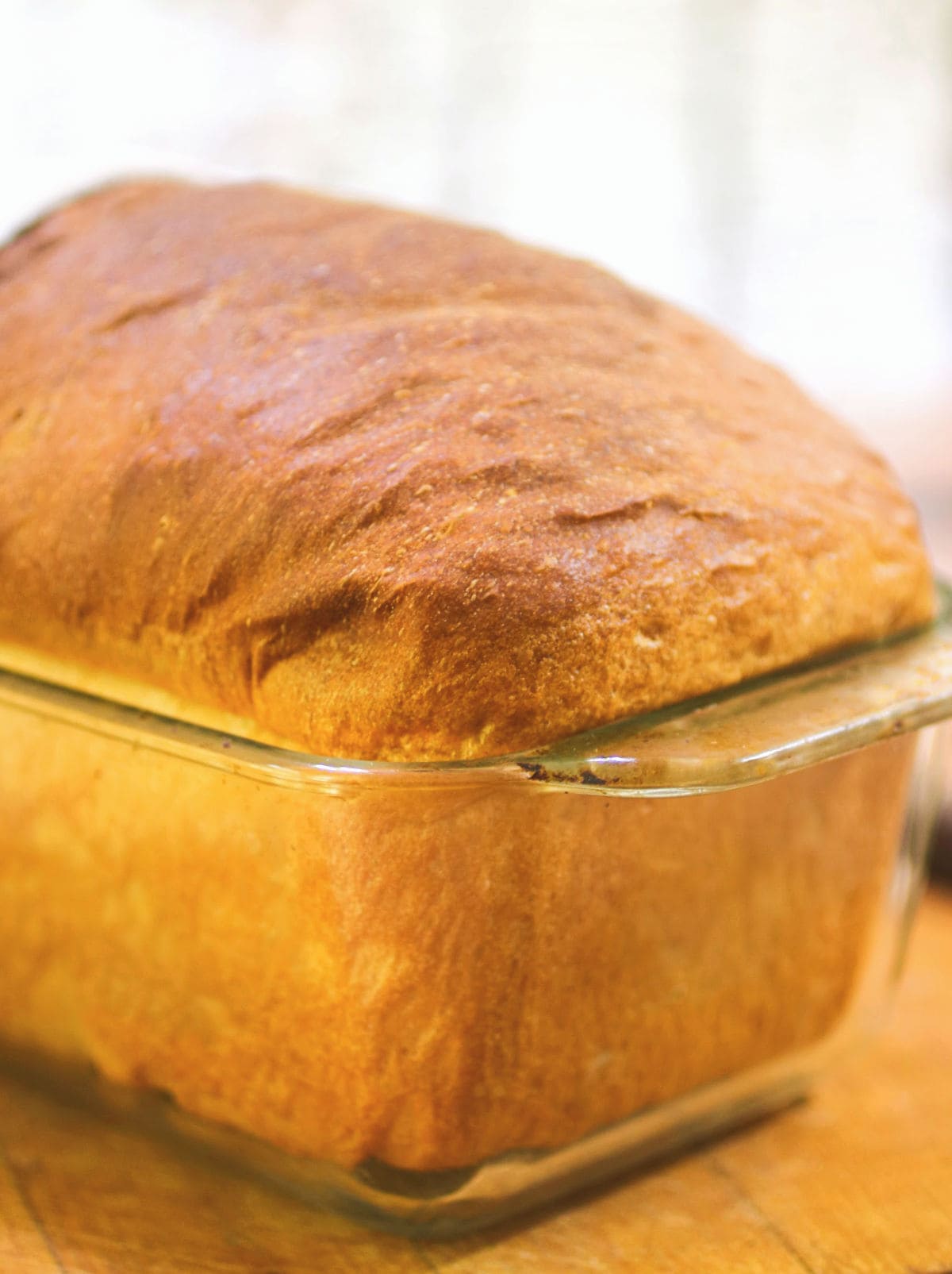 A finished loaf of bread in a glass pan.