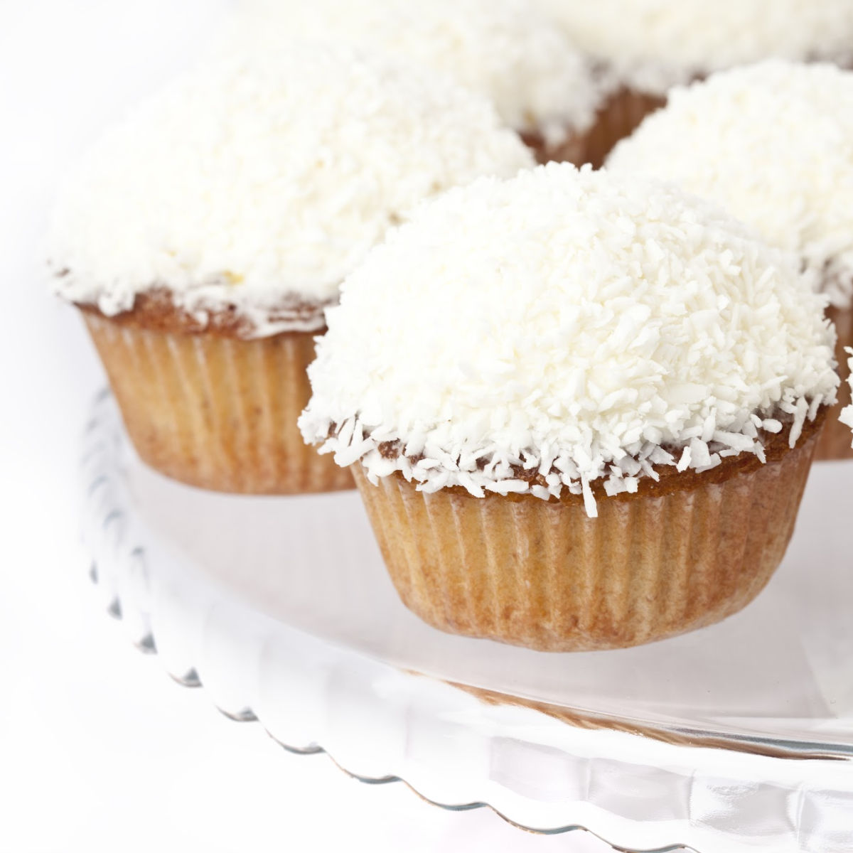 Coconut cupcakes on a plate.