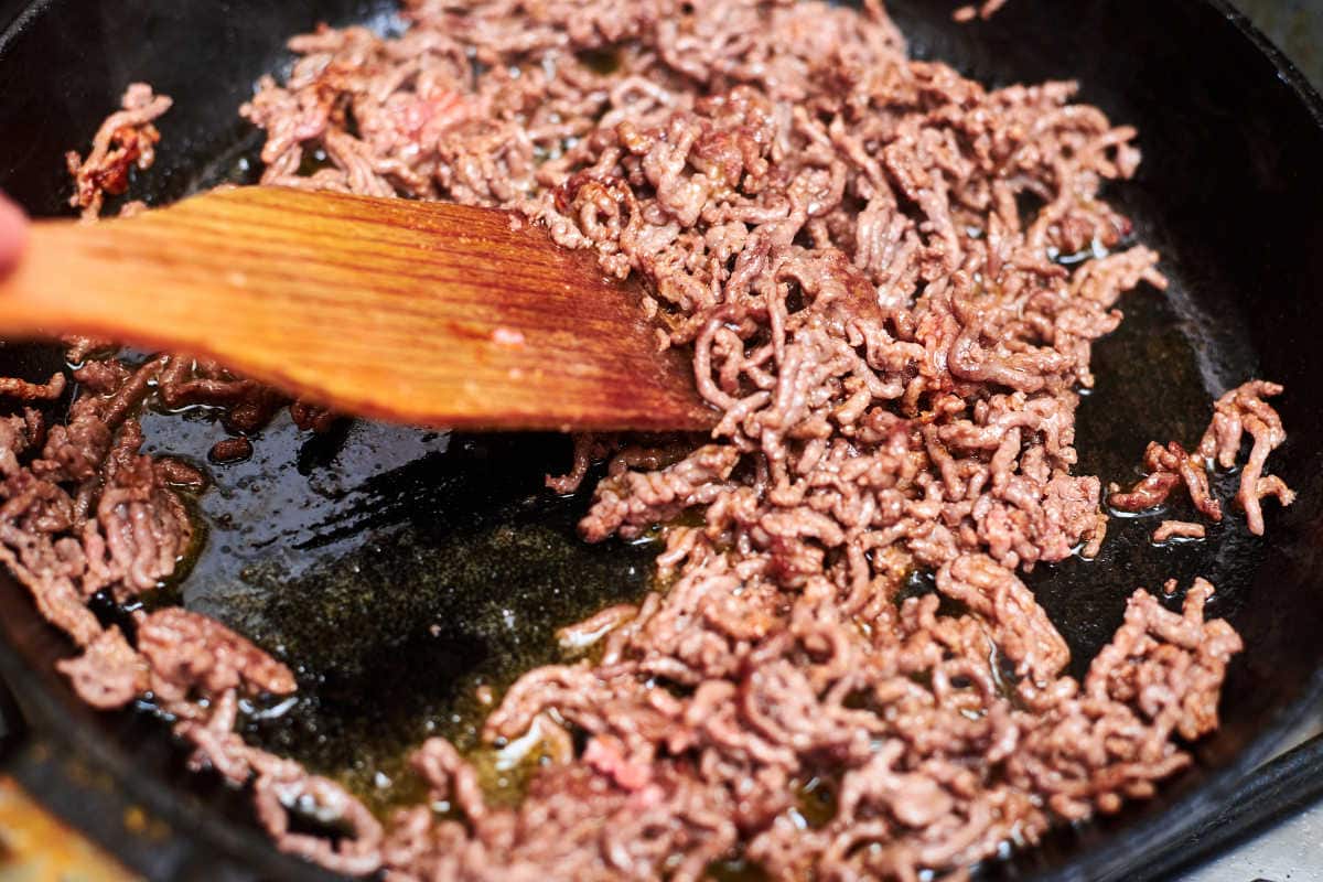 Ground beef being cooked in a skillet.