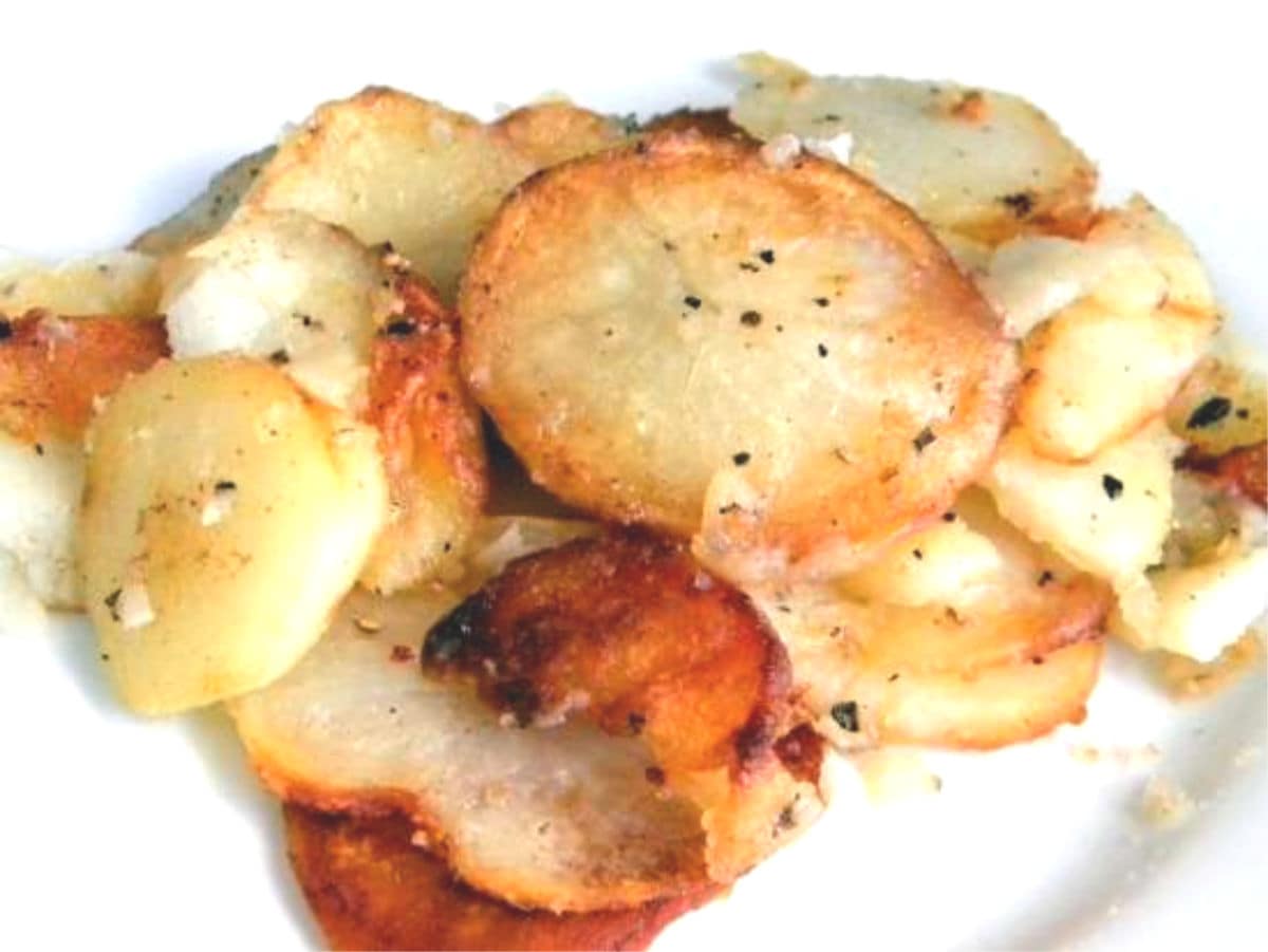 Close up of sliced, fried potatoes.