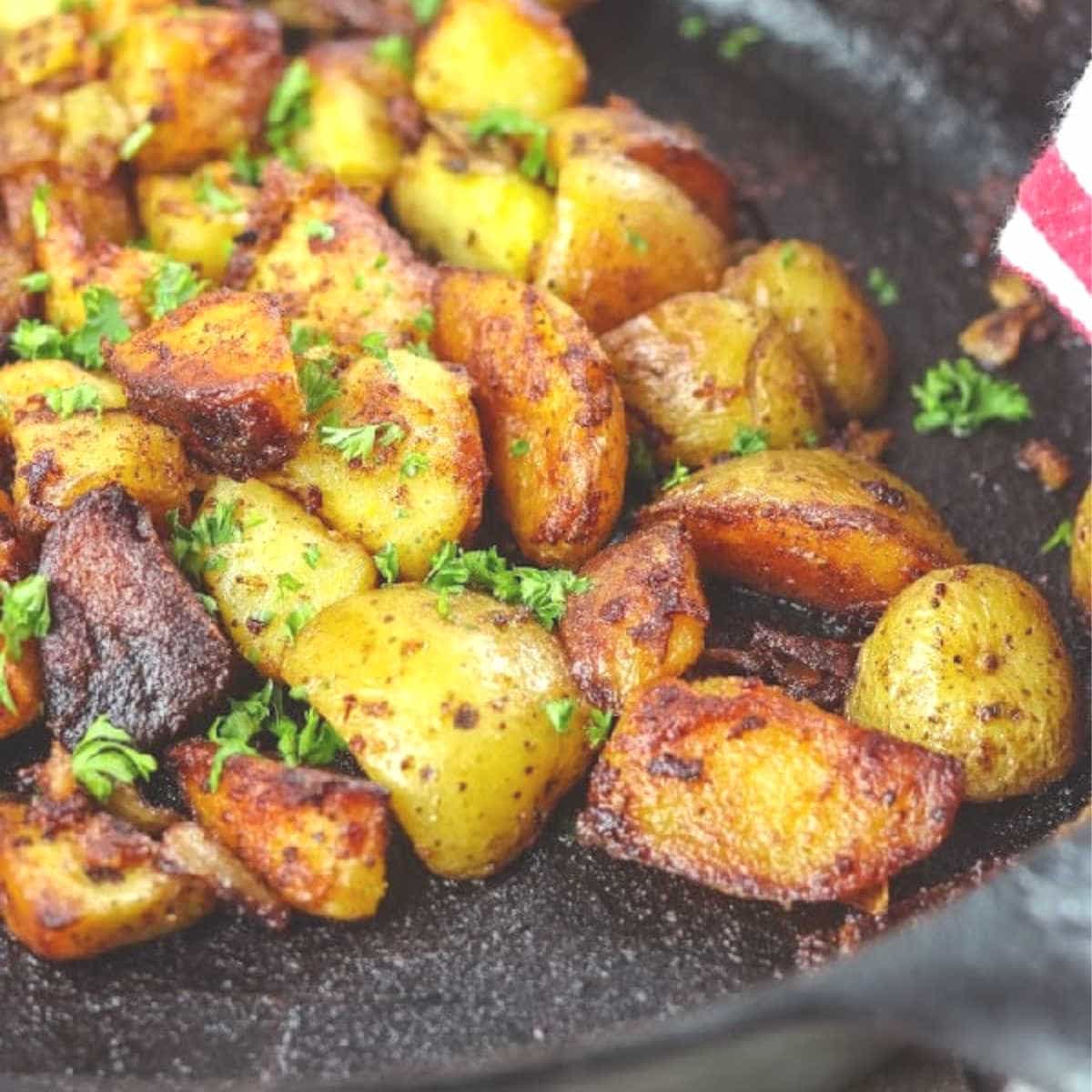 Closeup of potatoes frying in the pan.