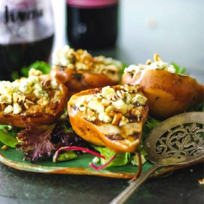 Grilled pear salad on a green serving dish.