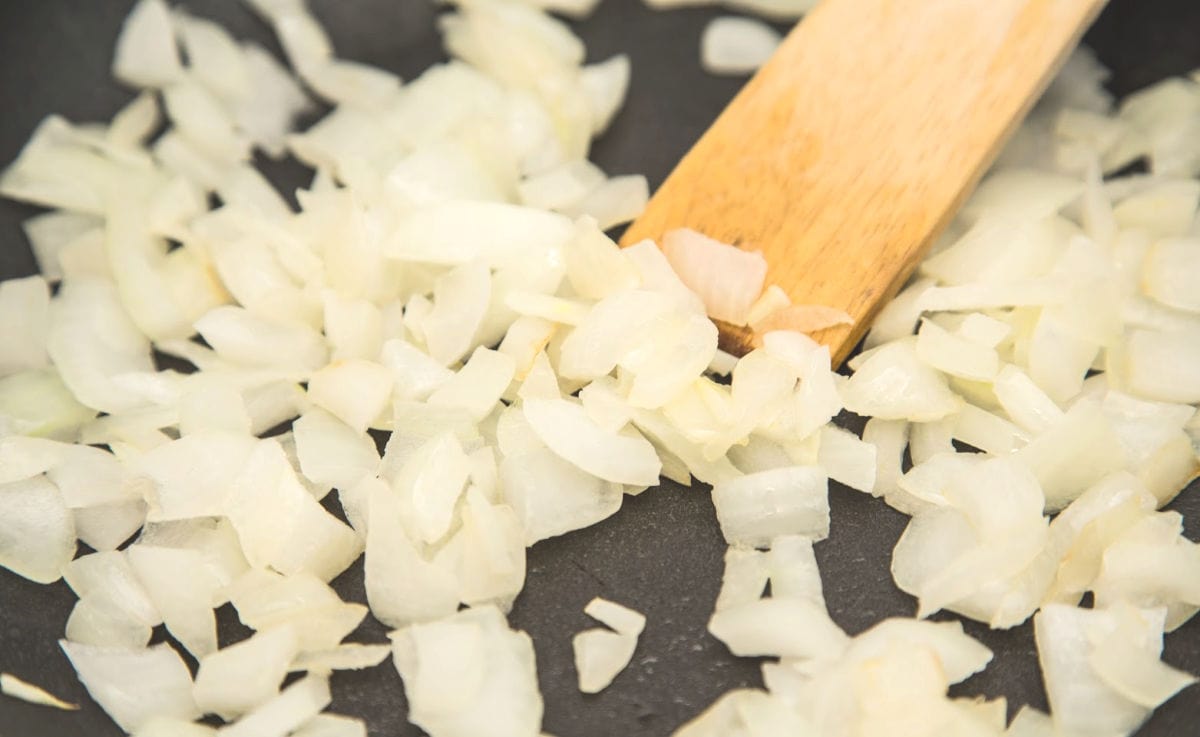 Onions cooking in a skillet.