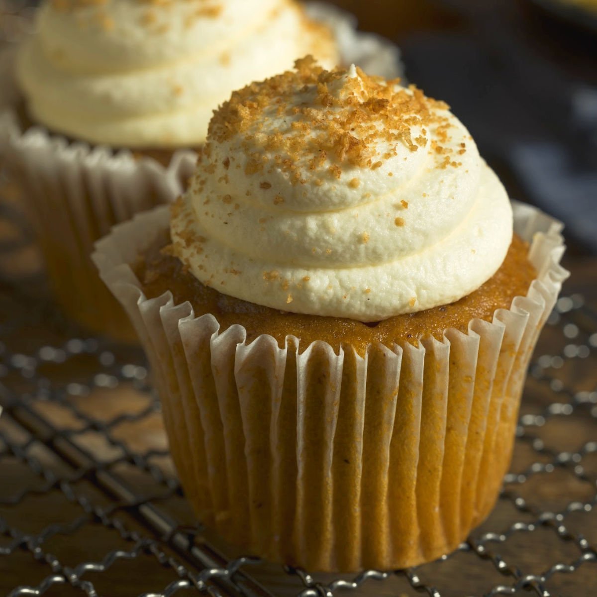 Spice cupcake with fluffy white frosting.
