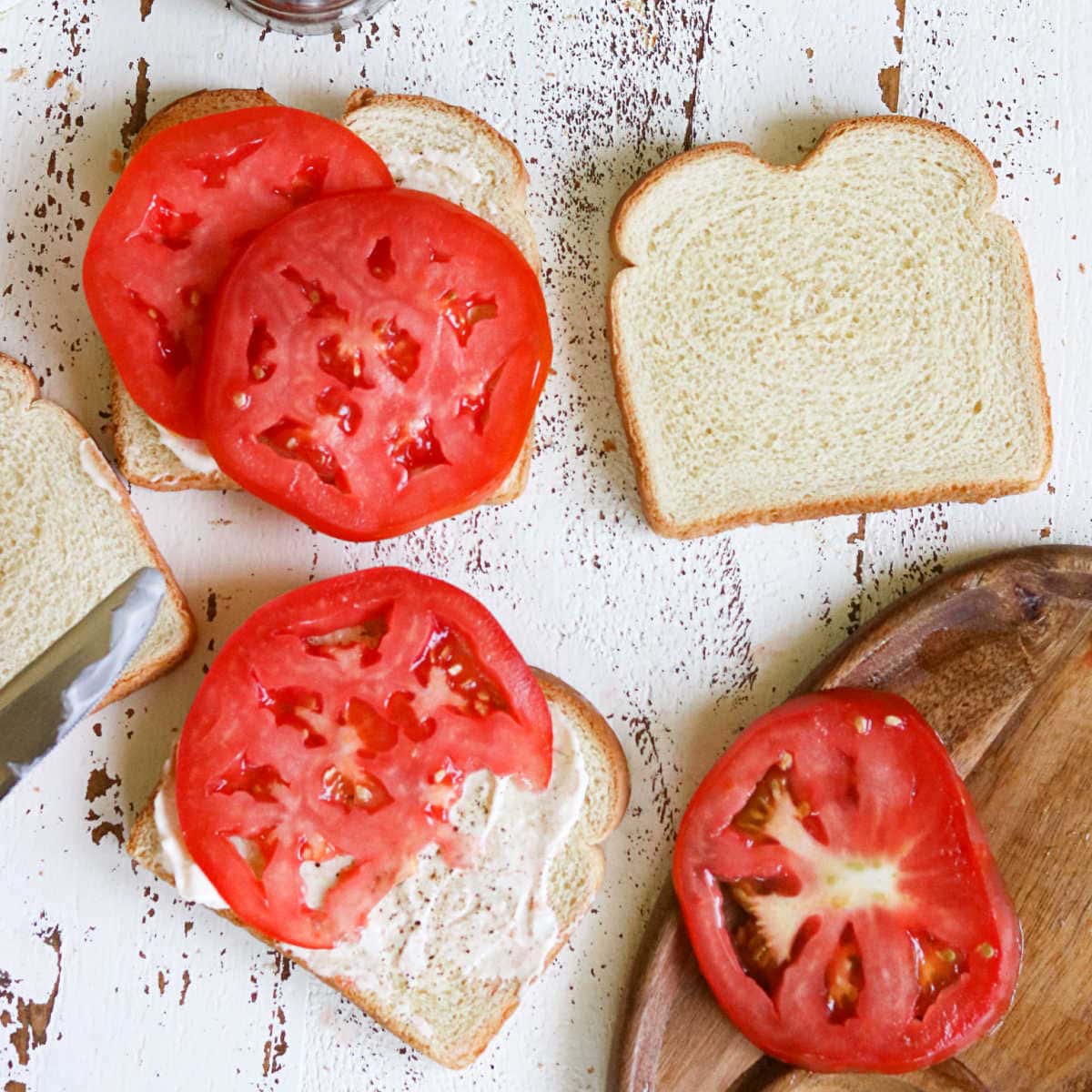 Sliced ripe tomatoes on white bread.