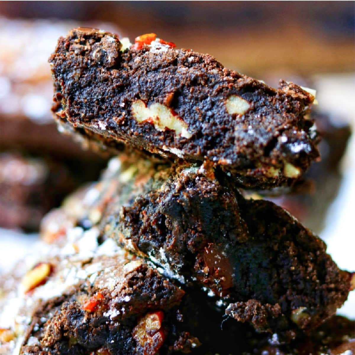 Stack of brownies with pecans.