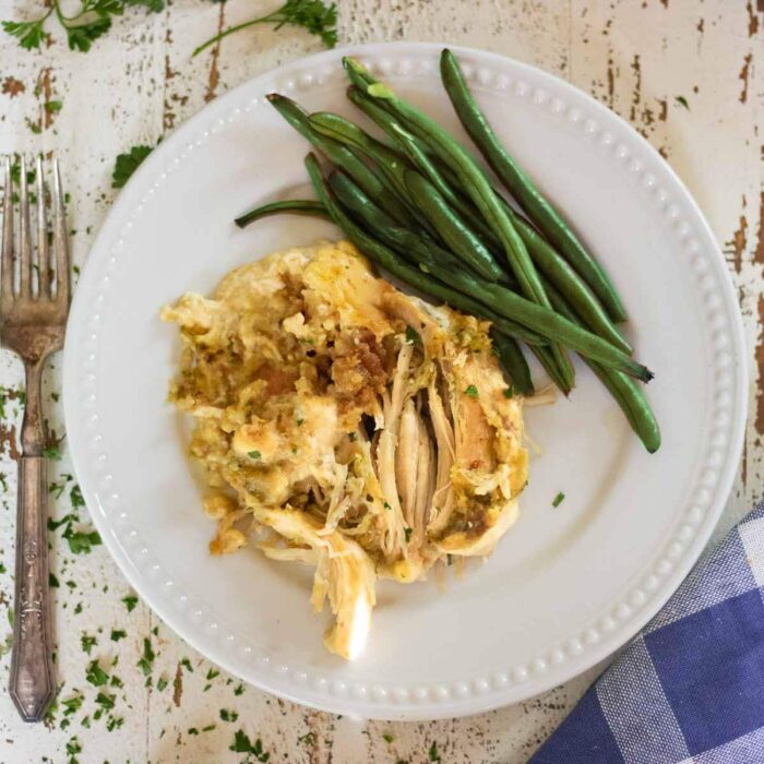 Serving of chicken and dressing with green beans on the side.