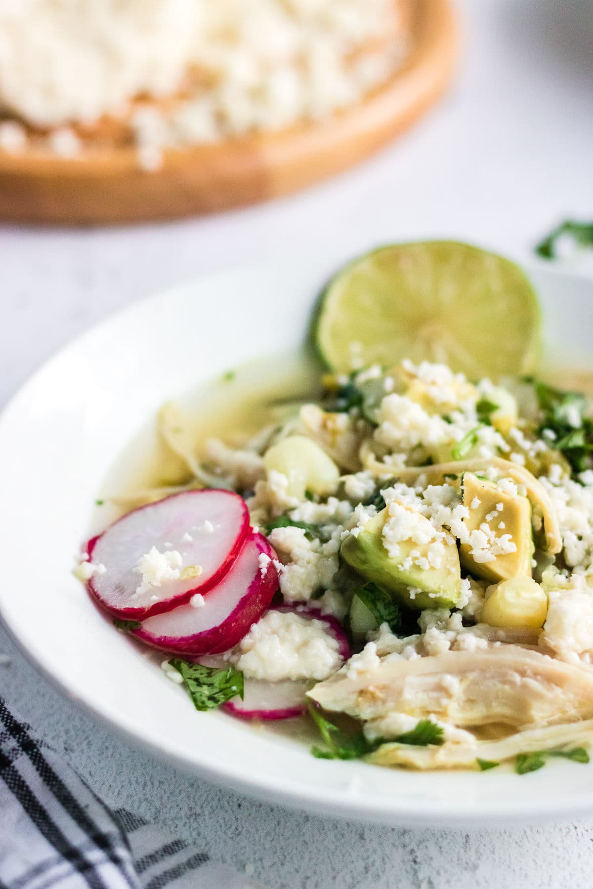 Close up of a bowl of green chicken pozole.