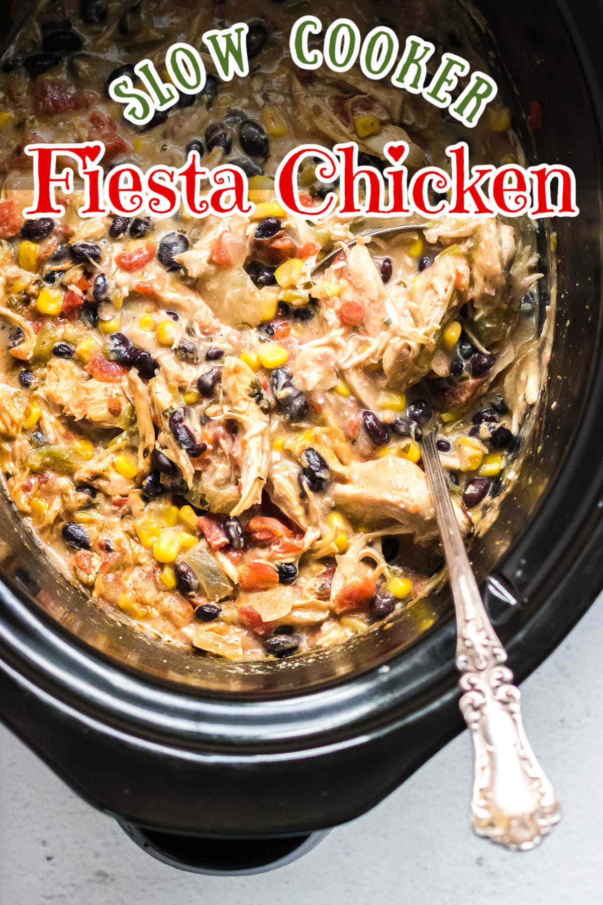 Creamy chicken, black beans, corn, and tomatoes in a crock pot.