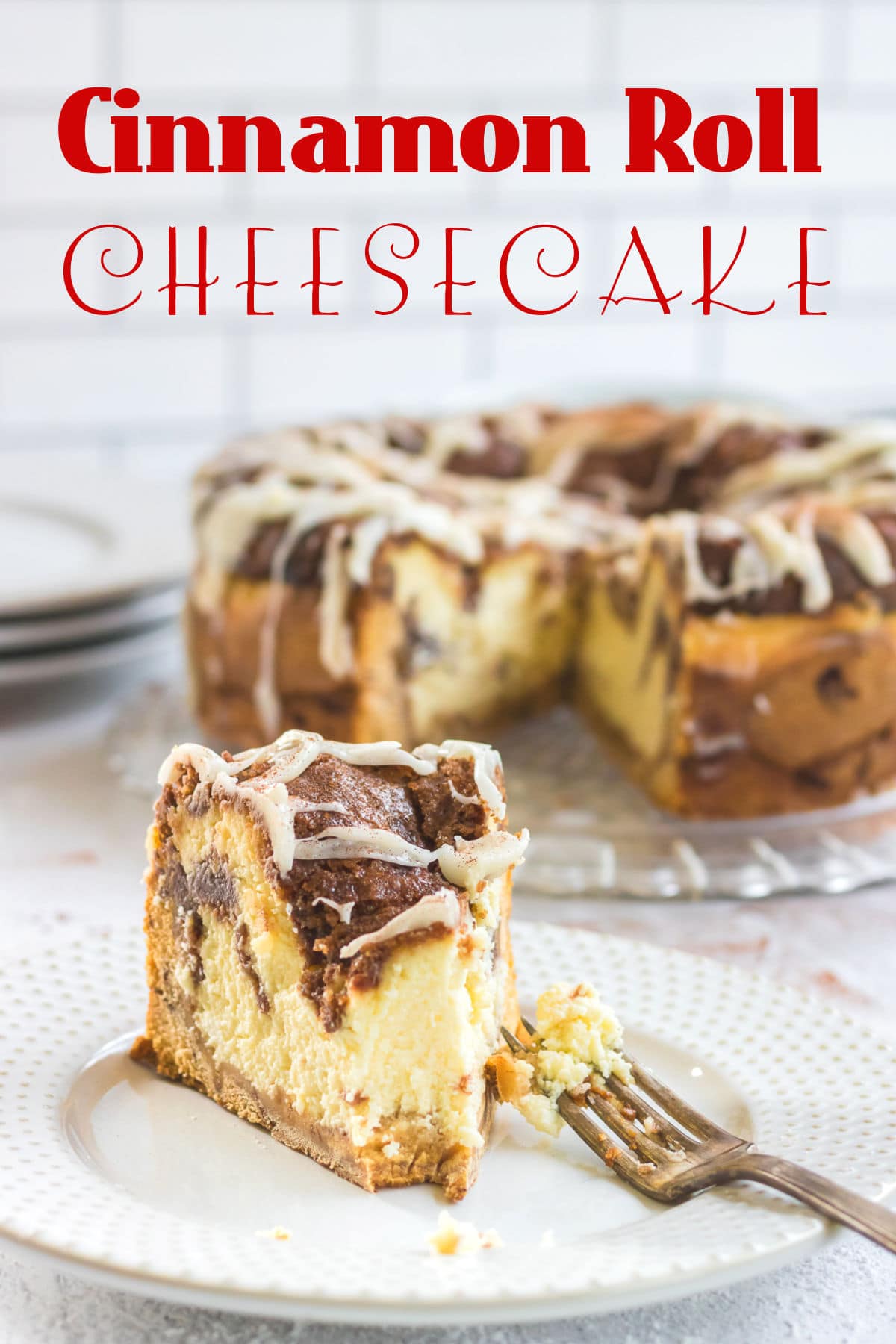 Slice of cinnamon roll cheesecake with title text overlay.