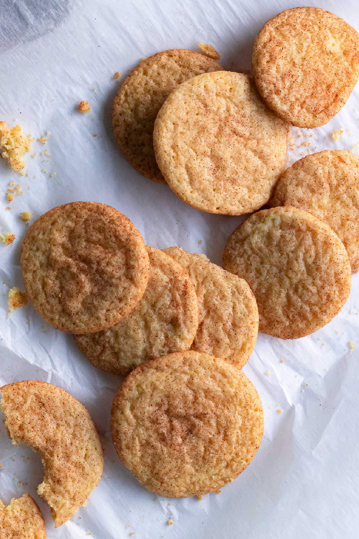 A pile of snickerdoodle cookies on parchment.