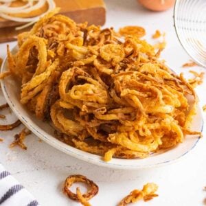 Close up of fried onions on a platter.