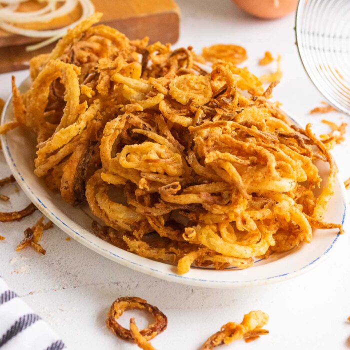 Close up of fried onions on a platter.