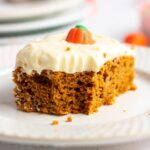 A serving of pumpkin cake with a bite taken out of it.
