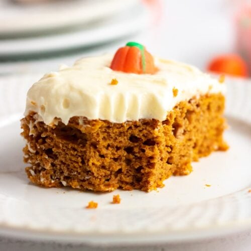 A serving of pumpkin cake with a bite taken out of it.