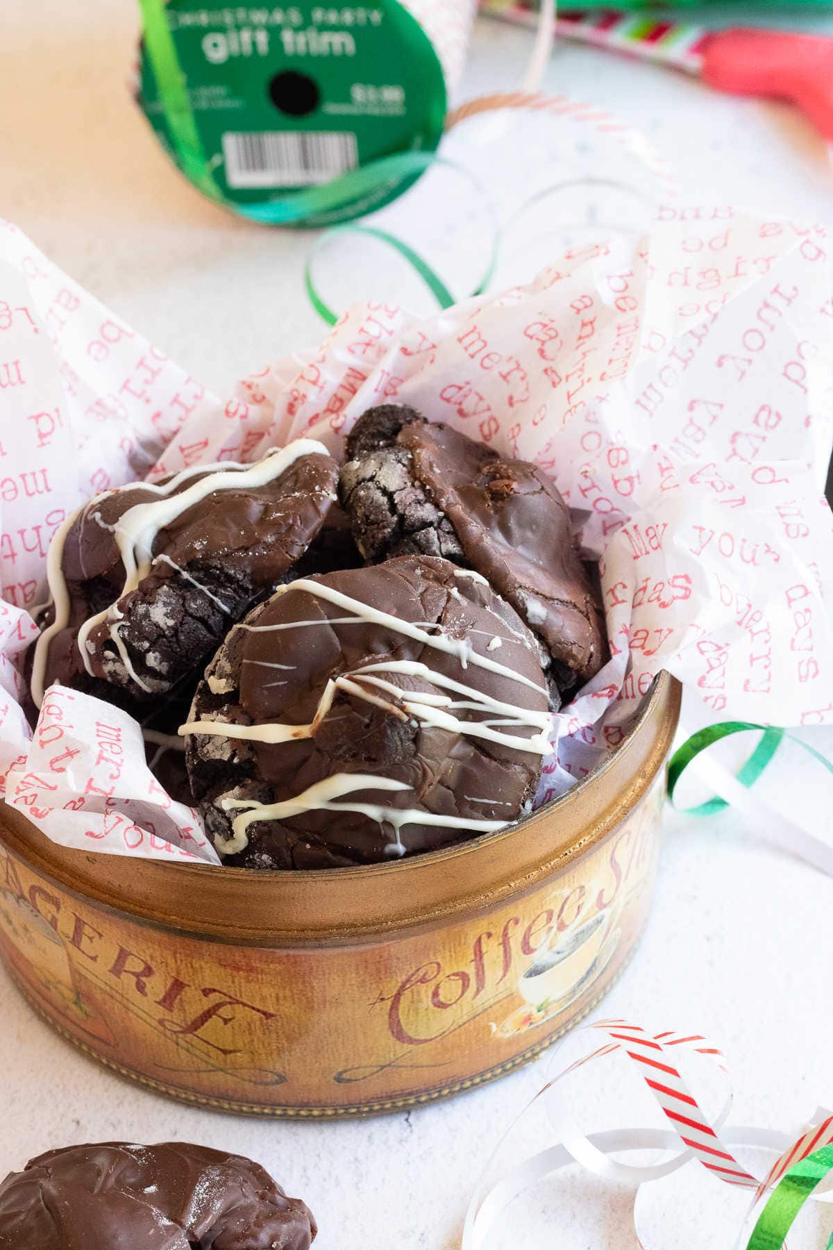 Overhead view of a tin filled with chocolate covered cherry cookies.