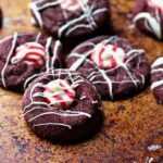 Red velvet Hershey's Kiss cookies on a baking sheet.