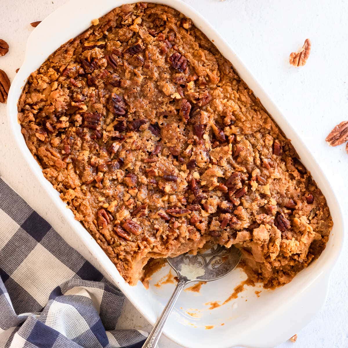 A sweet potato casserole with a serving removed.