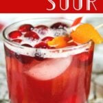 Cranberry whiskey sour in a glass. Text overlay for Pinterest.