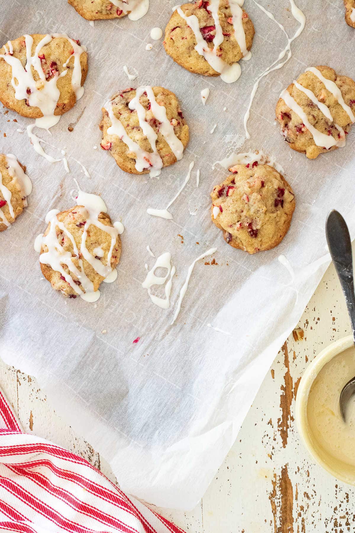 Cranberry orange cookies on parchment paper.