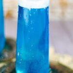 Sparkling blue cocktail with text overlay for pinterest.