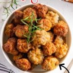Overhead shot of cream cheese sausage balls in a bowl with text overlay for Pinterest.