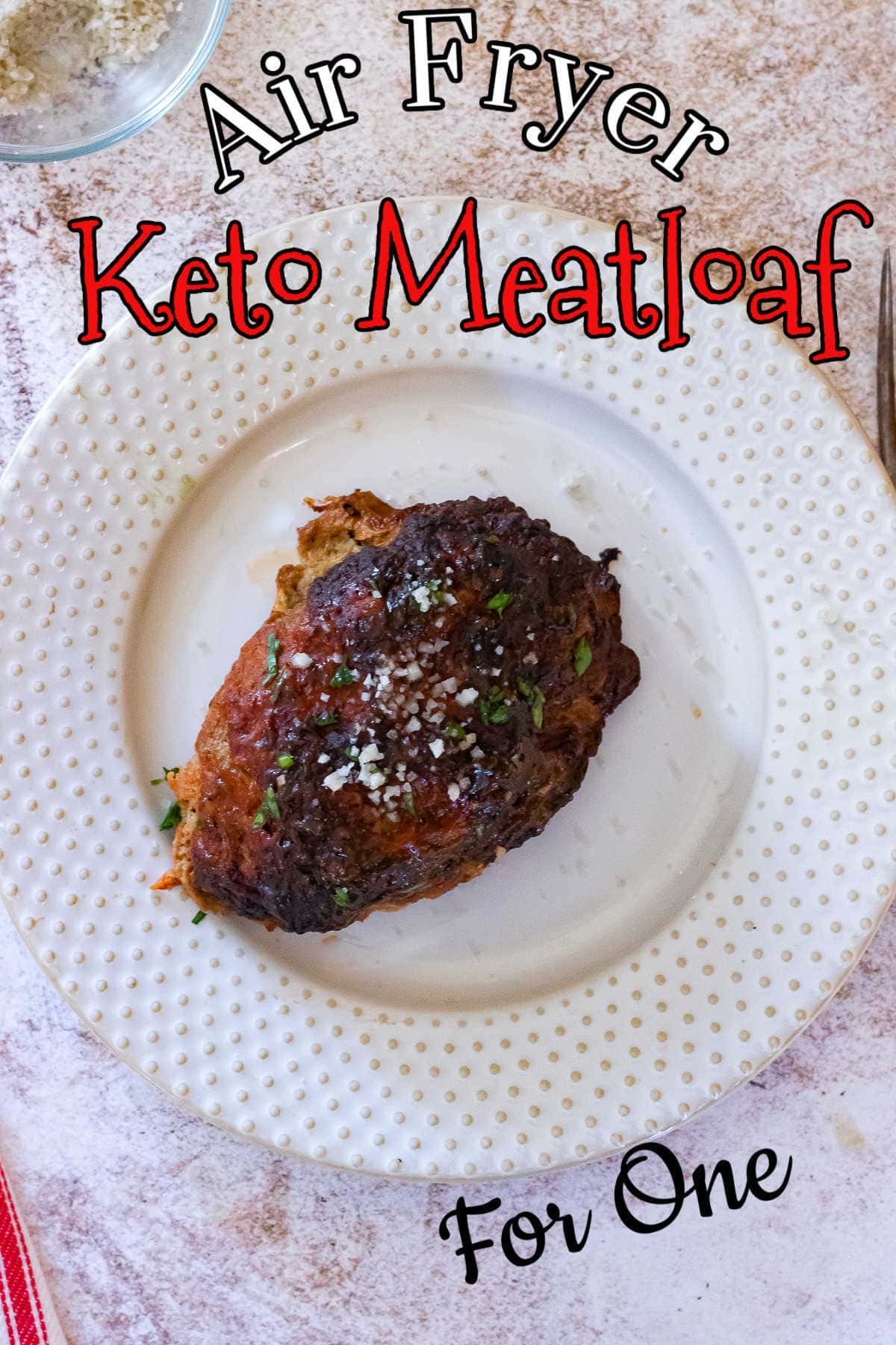 Serving of meatloaf on a white plate with the title text overlay.